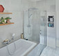 Bildunterschrift: Eine häufige Badsituation: Die Duschkabine ist direkt neben der Badewanne platziert. Die PEGA Pendeltür wurde mit einer feststehenden verkürzten Seitenwand kombiniert, die auf Maß gefertigt wurde. Foto: Kermi GmbH/akz-o