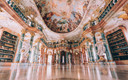 Bildunterschrift: Die Klosterkirche und der prachtvolle Bibliothekssaal des Benediktinerklosters Wiblinken zählen zu den berühmtesten Rokokobauten in Süddeutschland. Foto: Johannes Glöggler/Ulm/Neu-Ulm Touristik/akz-o